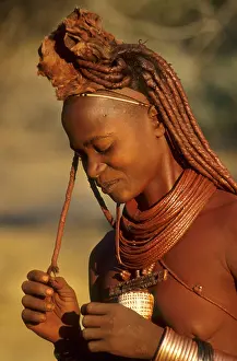Adornment Prints: Himba woman plays with her hair - a mixture of ochre and blood are used to groom hair Cunene River; Namibia