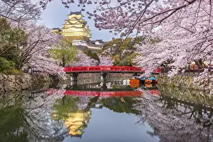 Himeji, Japan at Himeji Castle's surrounding moat in the spring season at dusk