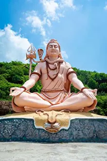 Meditating Prints: Hindu god Shiva sculpture sitting in meditation. Yoga and meditation concept