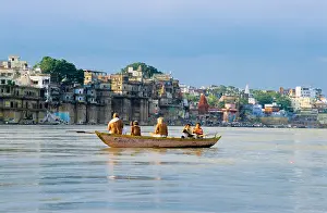 Banks Prints: Hindu pilgrims at dawn in a boat on the river Ganges in Varanasi, India