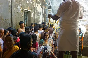 Indian People Prints: Hindu pilgrims receiving the holy bath at the Ramanathaswamy Temple in Rameswaram
