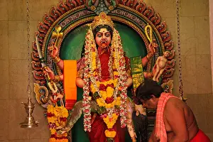 Evil Prints: Hindu priest during a ceremony inside the Sri Veeramakali Aman temple in Singapore Asia