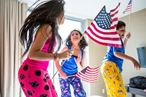 Pajamas Prints: Hispanic children jumping with American flags
