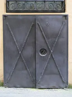 Wrought Iron Prints: Historic door made of vertical metal plates with numerous rivets