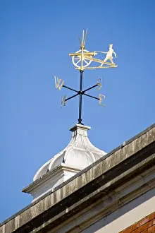 Compass Prints: An historic weather vane showing a fusilier wearing the uniform of the King's Royal Hussars firing a cannon