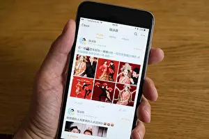 Smart Phone Prints: Home screen of Chinese social media website Weibo on a smart phone