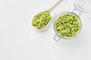 Body Care Prints: Homemade green body scrub in a glass jar on a white background
