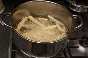 Potatoes Prints: Homemade potato chips frying in a pan of hot oil