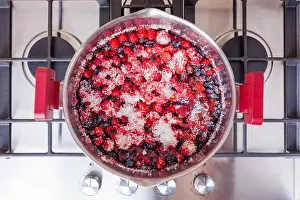 Saucepan Prints: Homemade strawberry jam cooking on gas stove