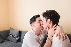 Pajama Prints: Homosexual men couple in pajamas kissing and touching each other