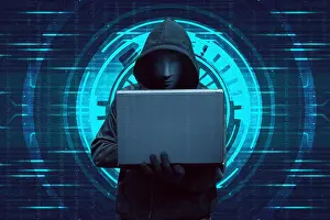 Informations Prints: Hooded hacker typing on laptop while standing
