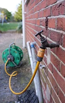 Hose Prints: a hosepipe connected to an outside tap to water garden