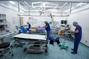 Concentrating Prints: Hospital staff in an operating theatre preparing for an operation