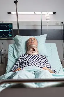 Suffering Prints: Hospitalized senior laying unconscious in hospital room bed wearing neck brace collar having serious health injury