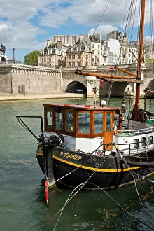 Stay Prints: House boats moored on banks of River Seine near Pont Neuf bridge. Central Paris, France