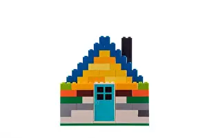 Lego Prints: House made of classic building blocks and bricks, white studio background