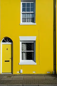 Residential District Prints: House painted bright yellow, terraced house in a city street