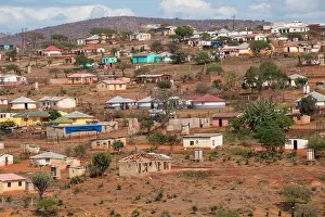 Zulu Prints: Housing and huts scattered informally on hill in rural south africa