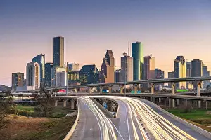 Houston, Texas, USA downtown city skyline and highway at dusk