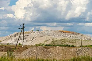 Dump Prints: Huge city landfill. Garbage trucks handle large pile of different garbage