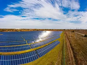 Green Power Prints: Huge solar power plant to use solar energy in a picturesque green field in Ukraine