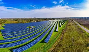 Green Power Prints: Huge solar power plant to use solar energy in a picturesque green field in Ukraine