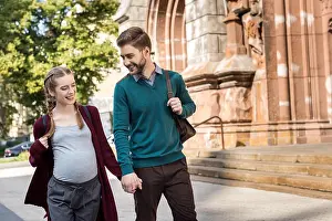 Young Adults Prints: husband and wife holding hands together while walking on street