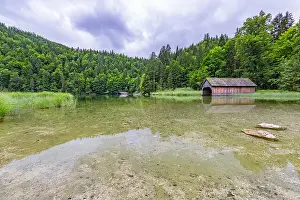 Hut on Braies Lake in Dolomiti mountains and Seekofel in background, Sudtirol, Italy. Idyllic Alpine landscape with lake house and calm lake water
