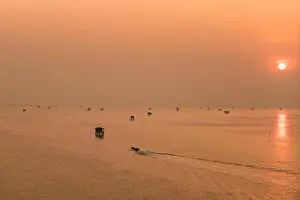 Hut and fishing boat on the sea with sunrise at Phetchaburi Province in Thailand
