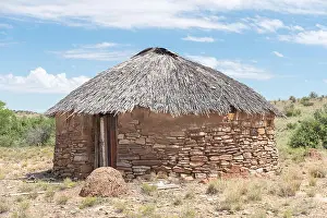 Thatch Prints: A hut with thatched roof built from stone next to the road between Steynsburg
