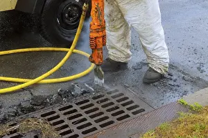 Destroyed Prints: A hydrohammer removes an old paving repair of roads in the city