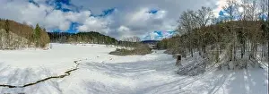 Snowbound Prints: Idyllic snow covered landscape with a little creek in the foreground framed by trees