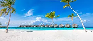 Idyllic tropical beach landscape with water villas and bungalows. Design of tourism summer vacation holiday destination concept. Luxury island beach