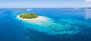 Halmahera Prints: An idyllic tropical island is surrounded by reef in the Halmahera Sea