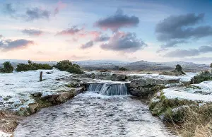 Rising Prints: An idyllic winter scene with snow on the ground and a beautiful waterfall