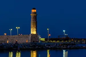 Rocky Landscape Prints: The illuminated Rethymno lighthouse at dusk