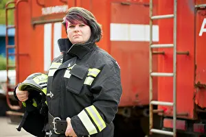 Urgency Prints: Image of brunette firefighter standing next to firefighters car on street