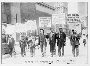 Hardship Prints: The image captures a parade of unemployed men carrying signs in New York