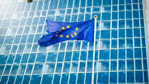 Council Prints: Image of EU flag fluttering on wind against high business office building made of concerete and glass