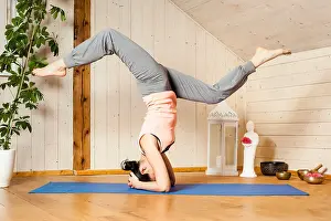 Conscious Prints: An image of a pretty woman doing yoga at home - Eka Pada Shirshasana