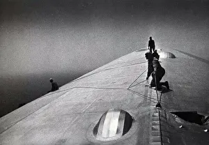Repair Prints: Image shows maintenance crewmen repairing a Zeppelin mid-flight