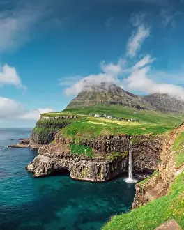 Incredible day view of Mulafossur waterfall in Gasadalur village, Vagar Island of the Faroe Islands, Denmark. Landscape photography