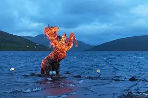 Sorvagsvatn Prints: Incredible evening scene with luminous mythical horse Nykur Nix Statue in Sorvagsvatn lake waters near the airport