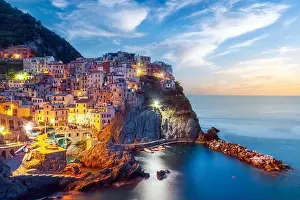 Cinque Terre Prints: Incredible morning view of Manarola city with costal rocks on a foreground