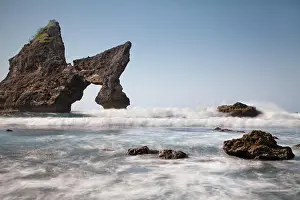 Karst Prints: Incredible natural arch sea stack named Batu Atuh on Nusa Penida tropical island paradise getaway