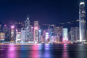 The incredible night cityscape view of lights on the water on Victoria Harbour in Hong Kong