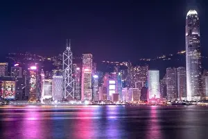 The incredible night cityscape view of lights on the water on Victoria Harbour in Hong Kong
