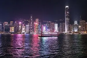 The incredible night cityscape view of lights on the water on Victoria Harbour in Hong Kong