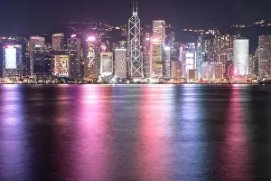 The incredible night cityscape view of lights on the water on Victoria Harbour in Hong Kong