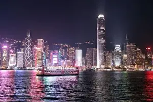 The incredible night cityscape view of lights on the water on Victoria Harbour in Hong Kong